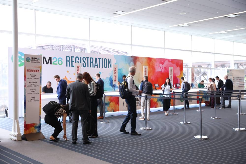 Crowd of people at a registration desk