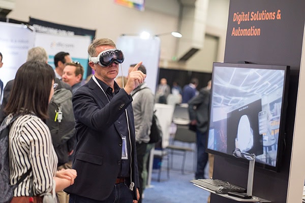 Startup-street-showcase Person using VR goggles at a conference