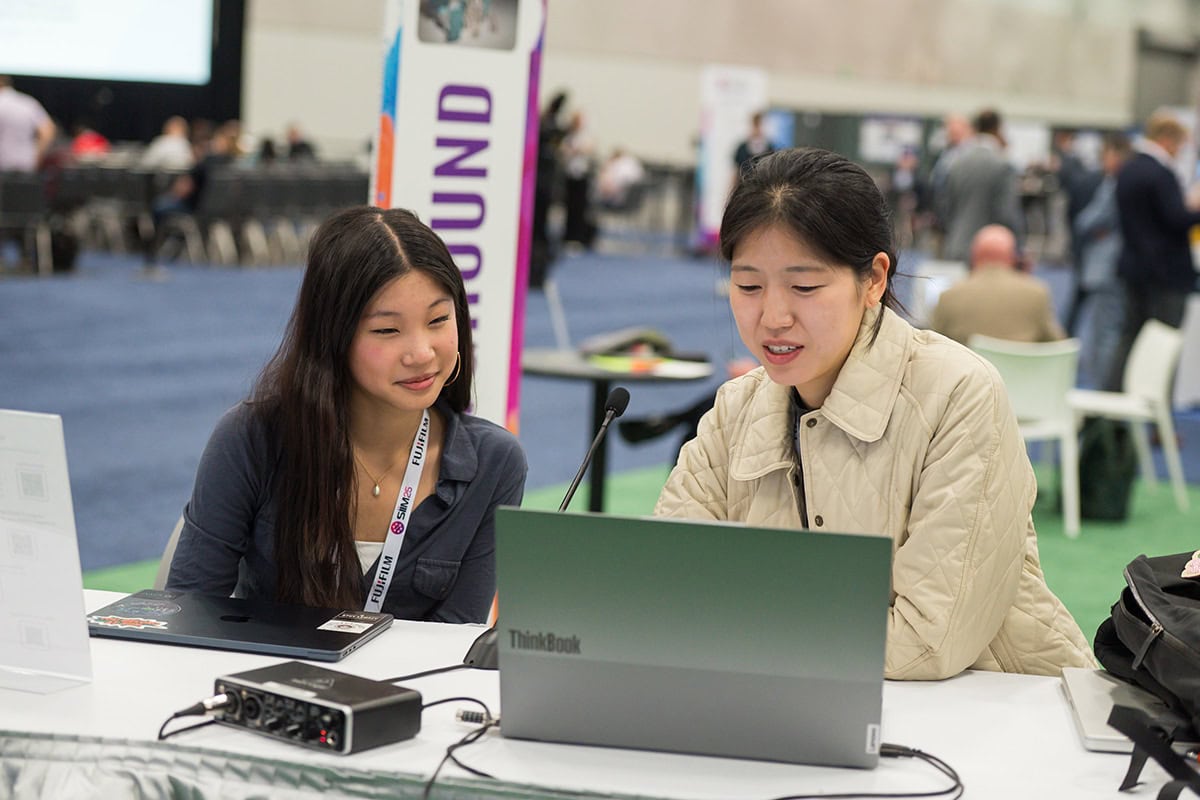 two women working on a laptop