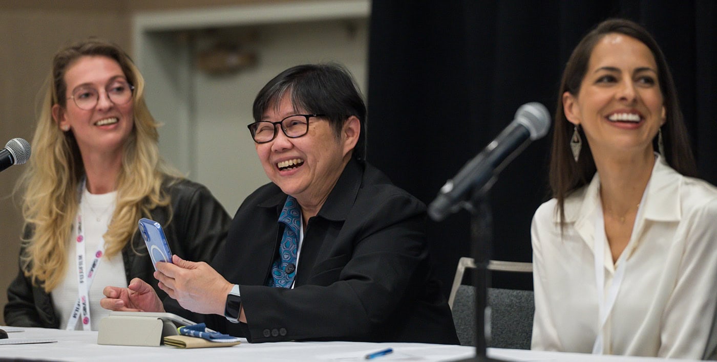 Diverse panelists smiling at SIIM Annual Meeting discussing radiology and medical imaging innovations.