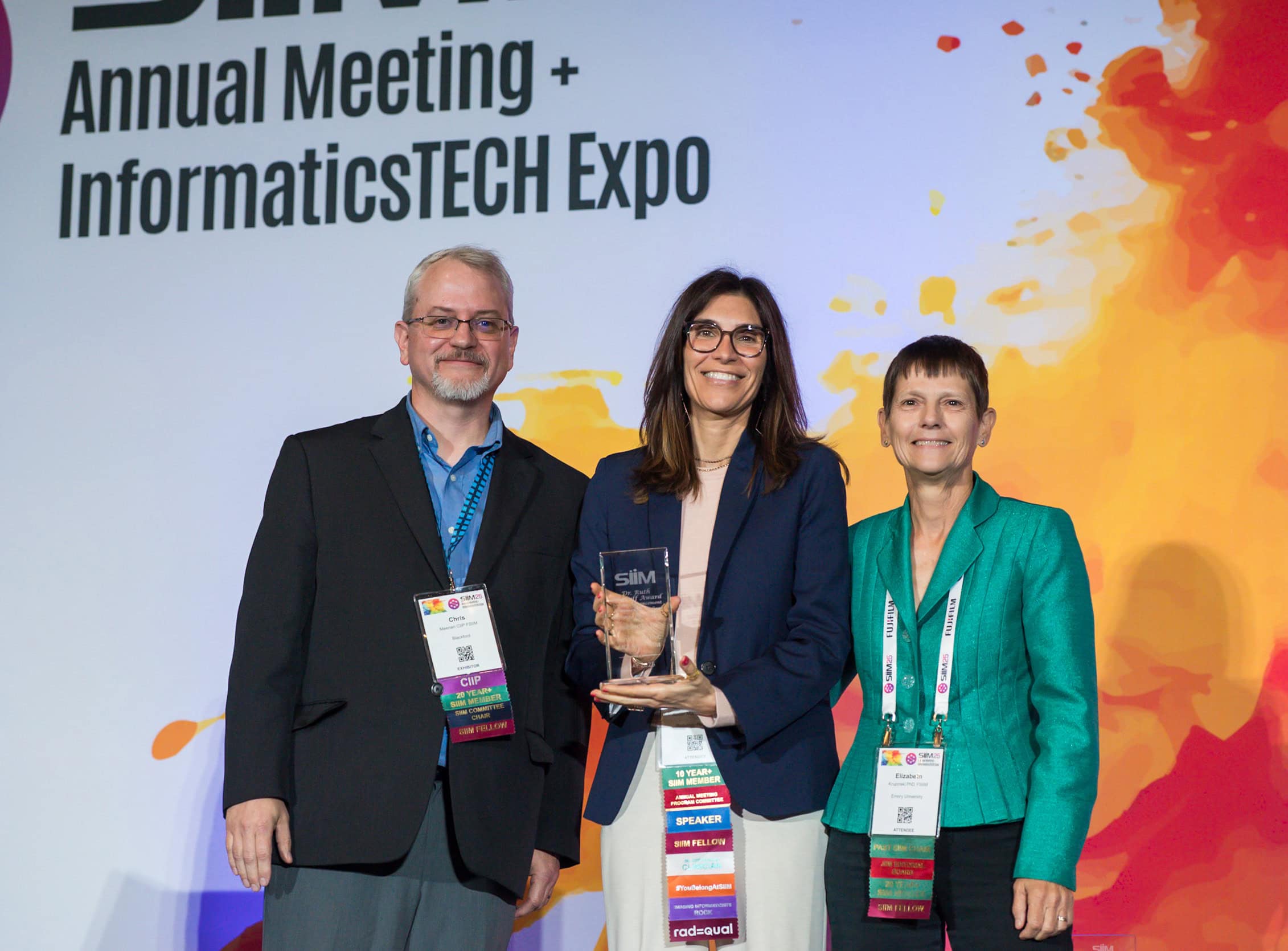 Innovative healthcare professionals receiving an award at the SIIM Annual Meeting and InformaticsTECH Expo, showcasing advancements in medical imaging technology and informatics.