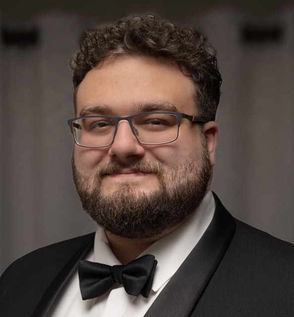 Portrait of Michael Passarella, a speaker or attendee at the SIIM Annual Meeting, wearing formal attire with a tuxedo and bow tie, smiling confidently.