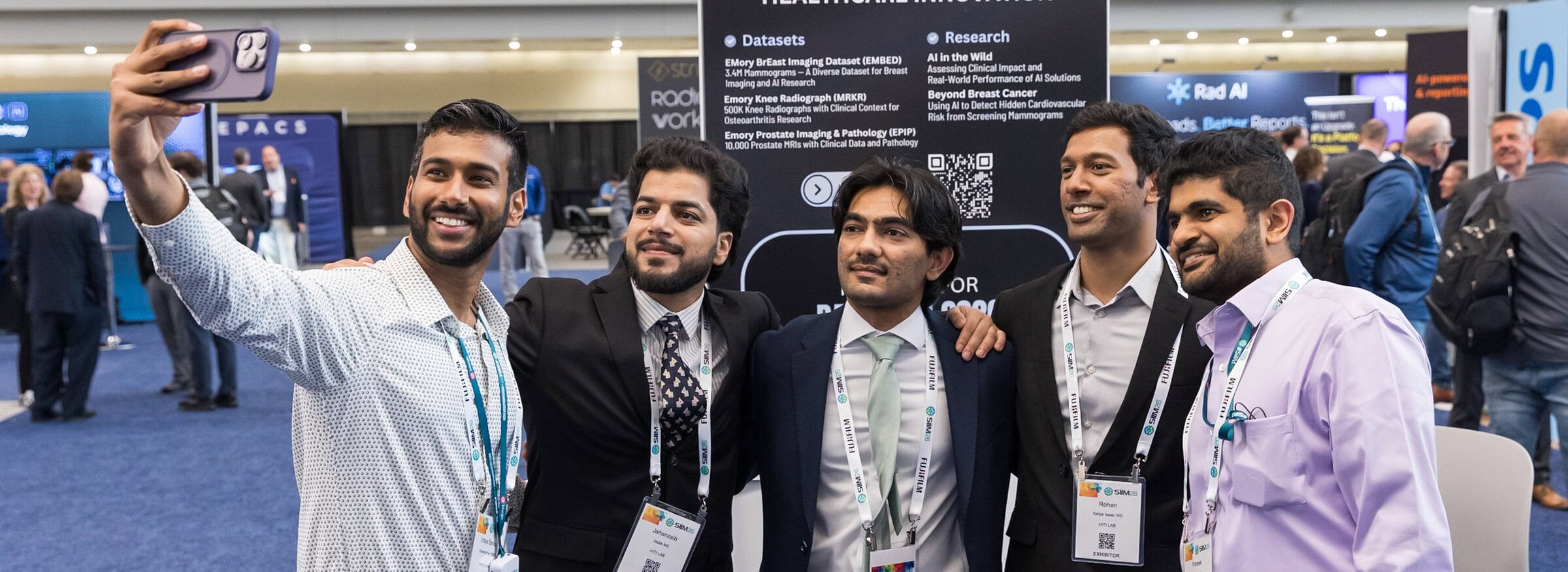 Group of diverse professionals taking a selfie at the SIIM Annual Meeting, showcasing networking and collaboration in medical imaging technology.