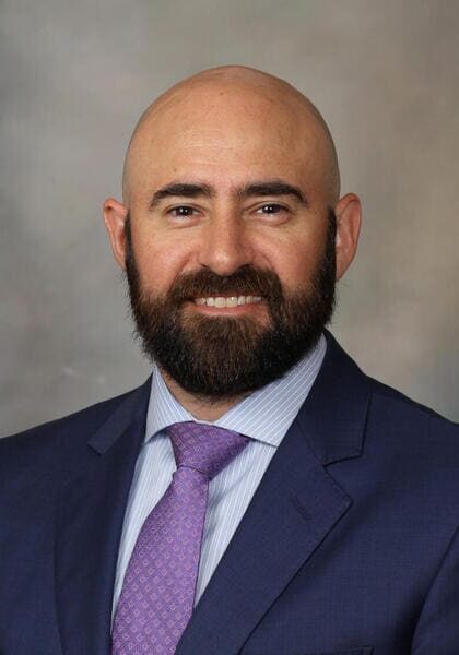 1. Professional male speaker at SIIM Annual Meeting, radiology and medical imaging conference, presenting on innovative healthcare technology solutions.