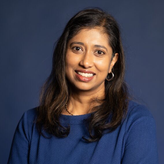 Professional woman smiling at SIIM Annual Meeting conference, emphasizing radiology and medical imaging innovations.