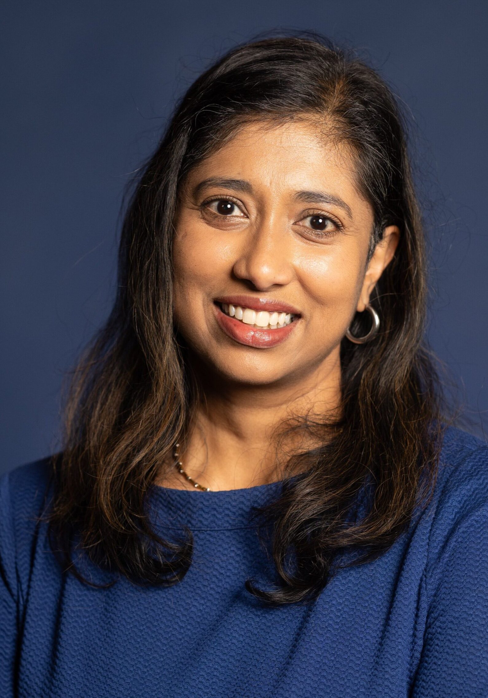 Professional woman smiling at SIIM Annual Meeting conference, emphasizing radiology and medical imaging innovations.