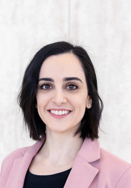Professional portrait of Ariana Familiar, PhD, smiling at the SIIM Annual Meeting, showcasing her expertise in medical imaging and informatics.