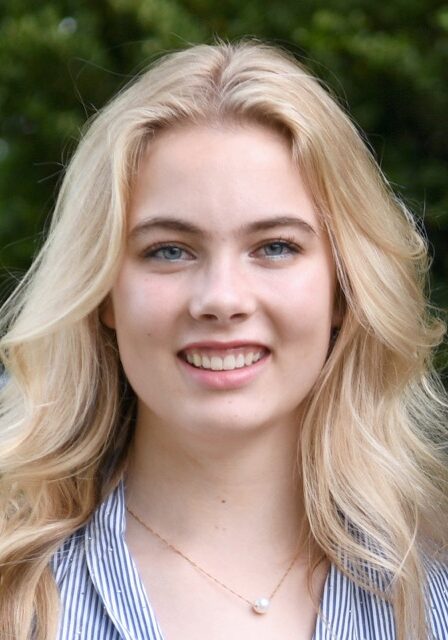Young woman smiling outdoors at SIIM Annual Meeting, showcasing enthusiasm for medical imaging and healthcare innovation.
