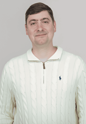 A young man smiling in a cream-colored sweater at the SIIM Annual Meeting, a leading event in medical imaging and informatics.