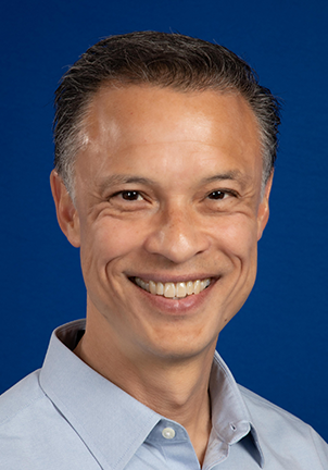 A smiling professional man at the SIIM Annual Meeting, showcasing advancements in medical imaging and informatics technology.