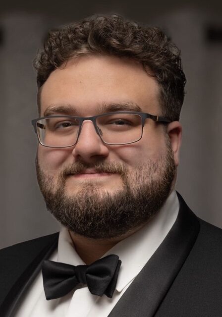 Portrait of Michael Passarella, a speaker or attendee at the SIIM Annual Meeting, wearing formal attire with a tuxedo and bow tie, smiling confidently.