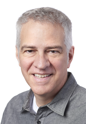 A man smiling at the camera during the SIIM Annual Meeting, showcasing professional attire and a friendly demeanor in a conference setting.
