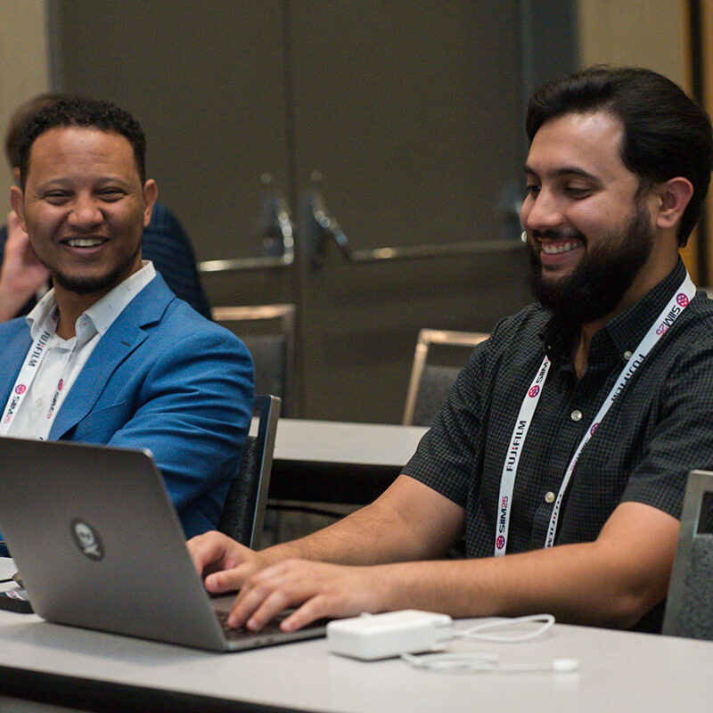 Diverse professionals at the SIIM Annual Meeting, engaging in medical imaging discussions and networking. Attendees showcase collaboration and technological innovation in radiology and healthcare.