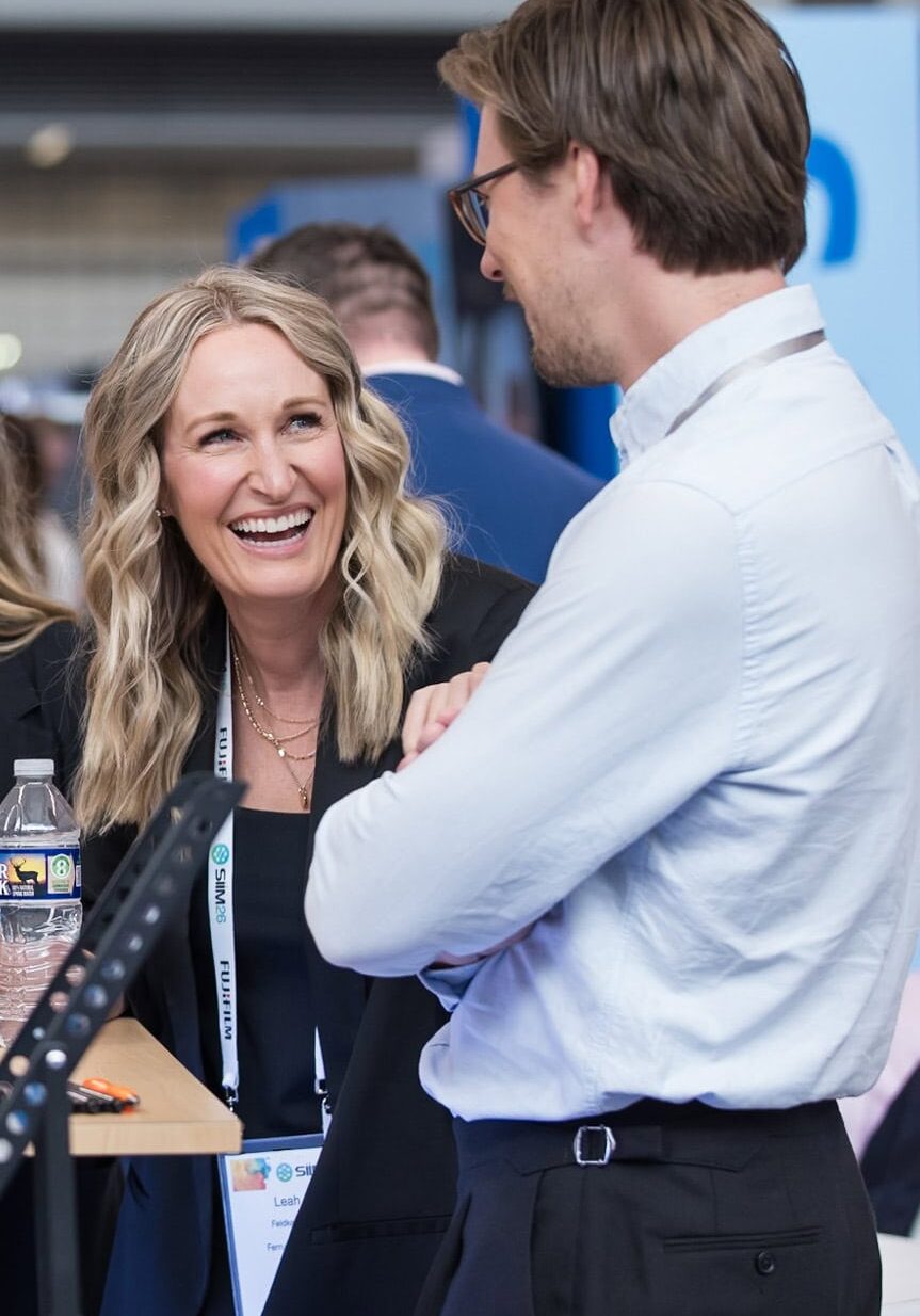 Attendees engaging in conversation at the SIIM Annual Meeting, showcasing professional networking and collaboration in medical imaging.
